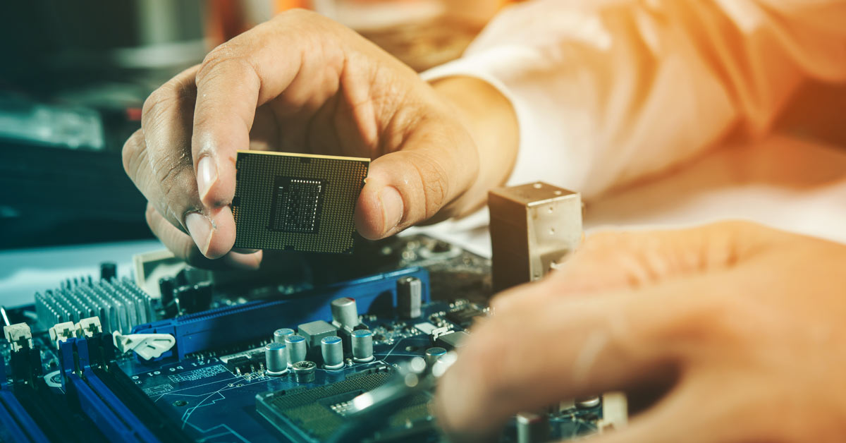 Engineer putting CPU in computer.